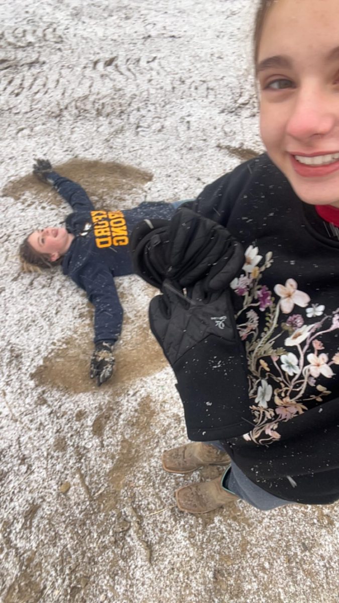 The girls making snow angels while doing barn work