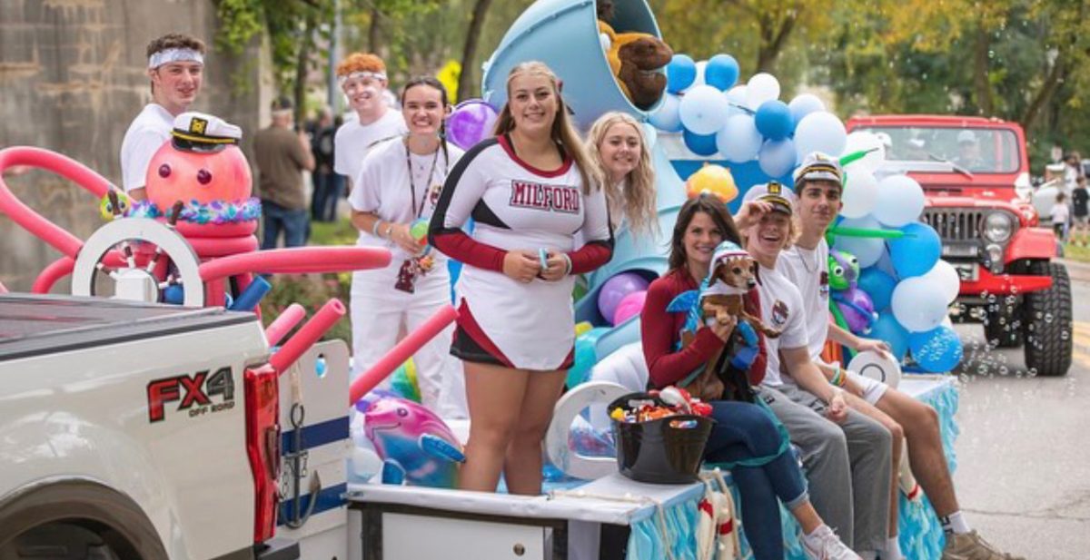 Seniors show off their hard work they put into their float at the homecoming parade. 