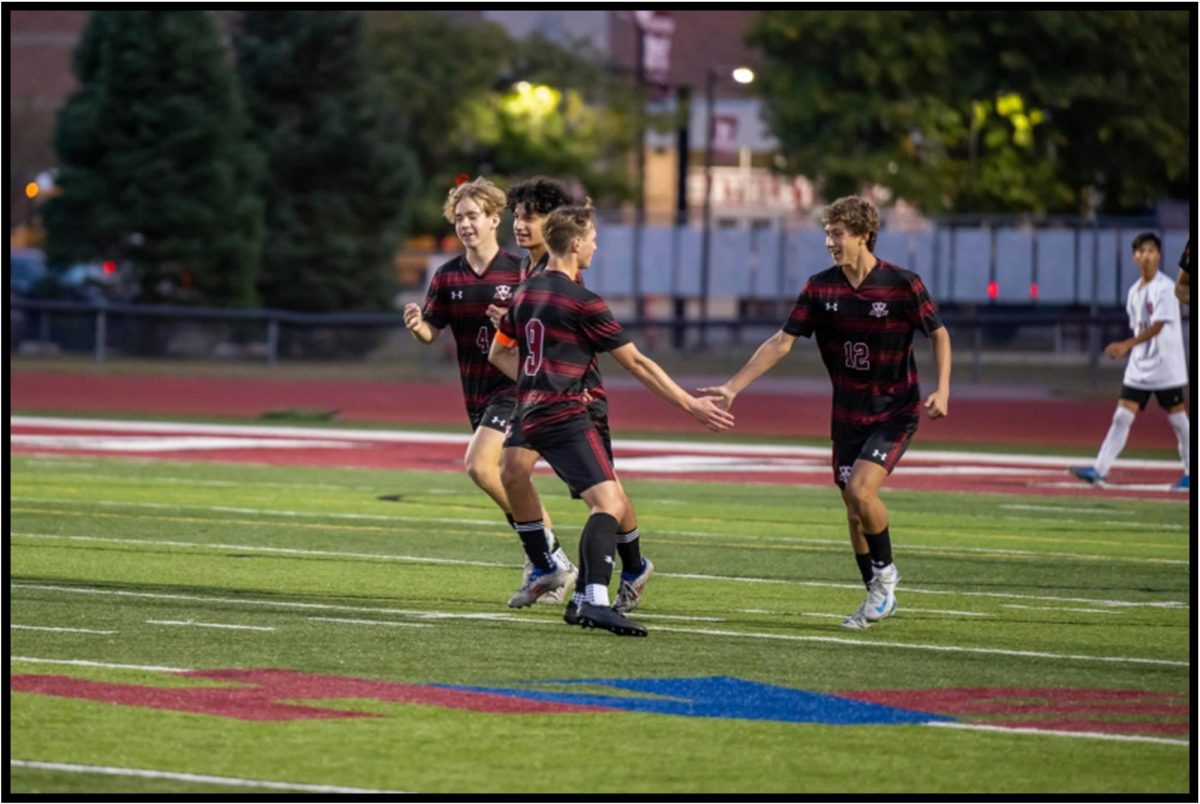 (Listed in order from right to left) Lucas Lansberry, Nick  Dziedzic, Anwar Brek and Brayden Kirby celebrating  after a goal.  
